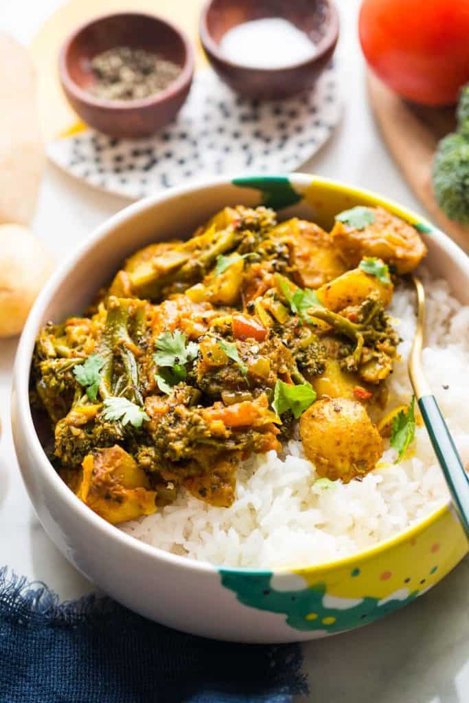 broccoli and potato curry in a bowl with rice