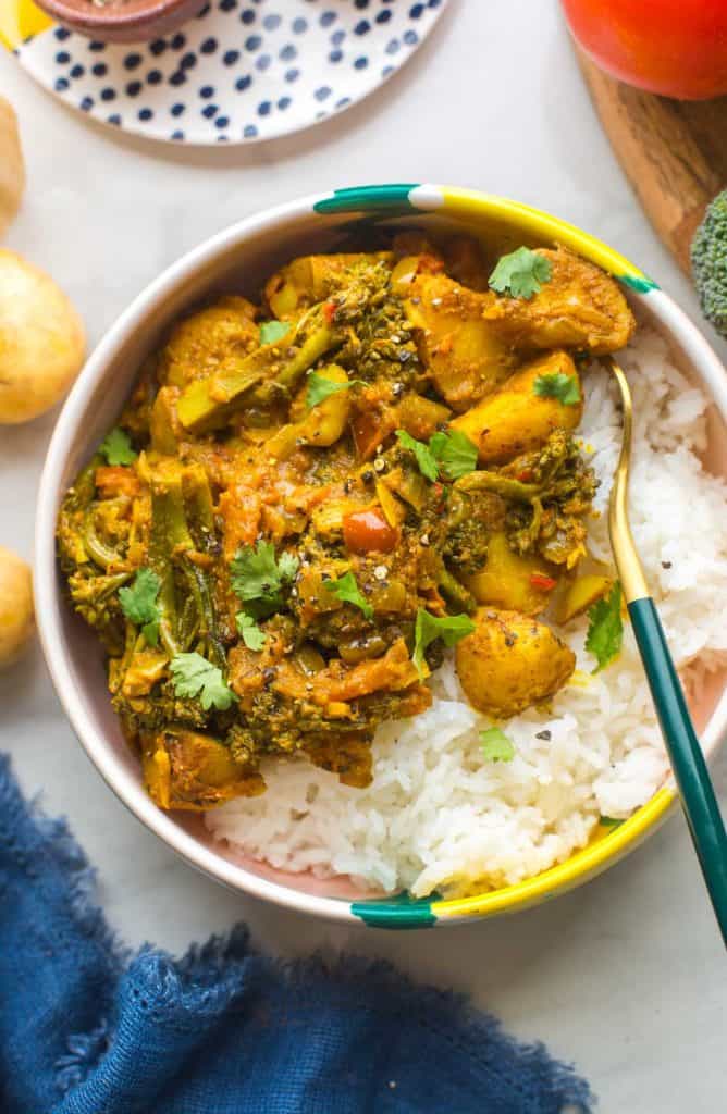 Stir Fried Broccoli Potato Curry in a bowl over rice