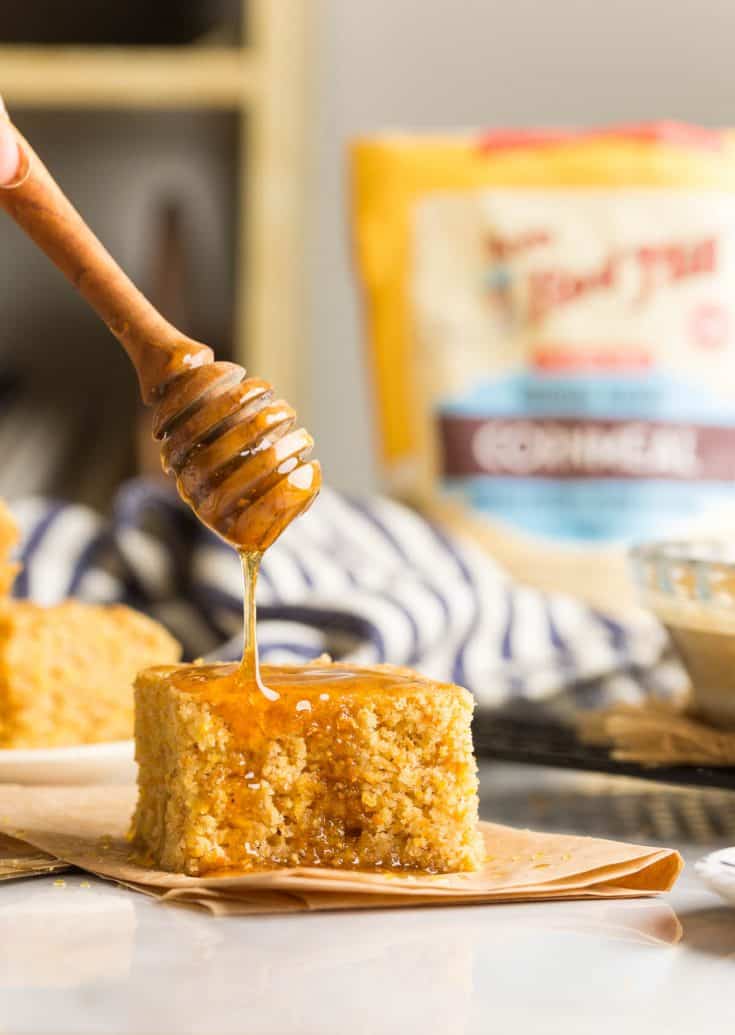 gluten free cornbread with honey drizzling over the top