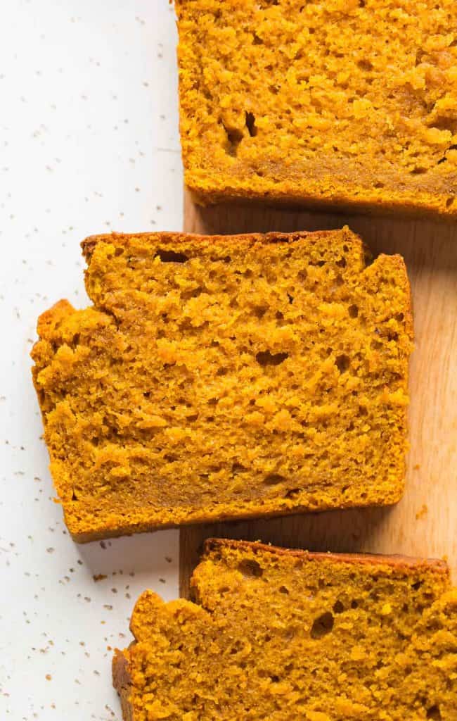 slices of pumpkin bread on a cutting board up close