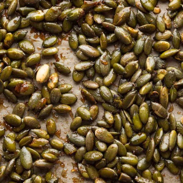 cinnamon spiced roasted pepitas on a baking sheet