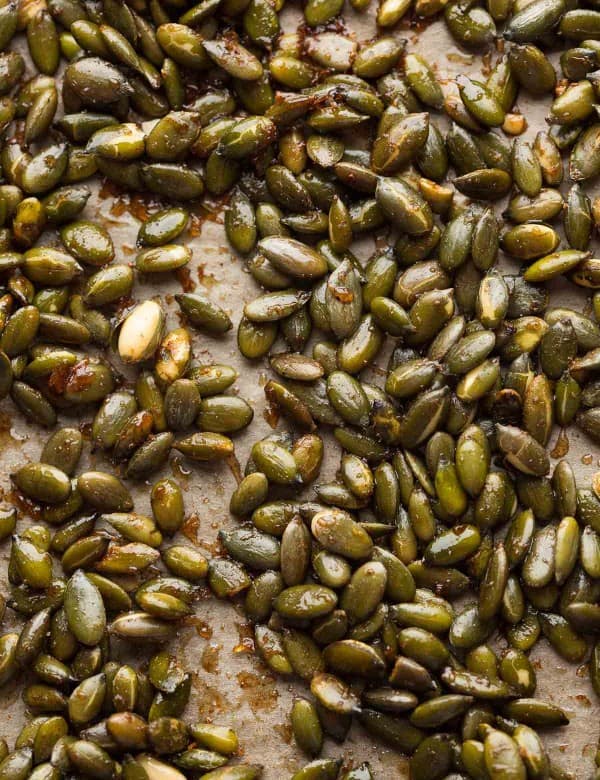 cinnamon spiced roasted pepitas on a baking sheet