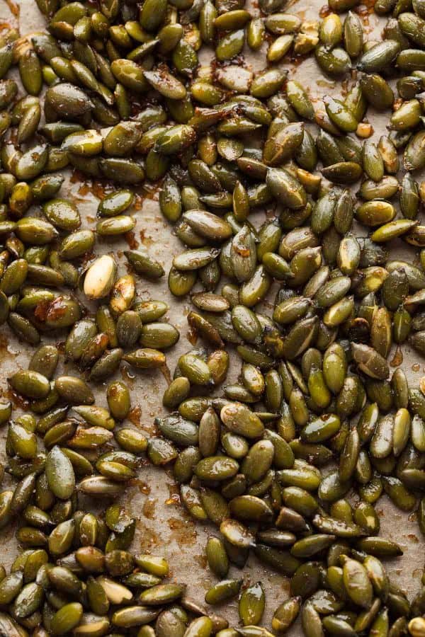 cinnamon spiced roasted pepitas on a baking sheet