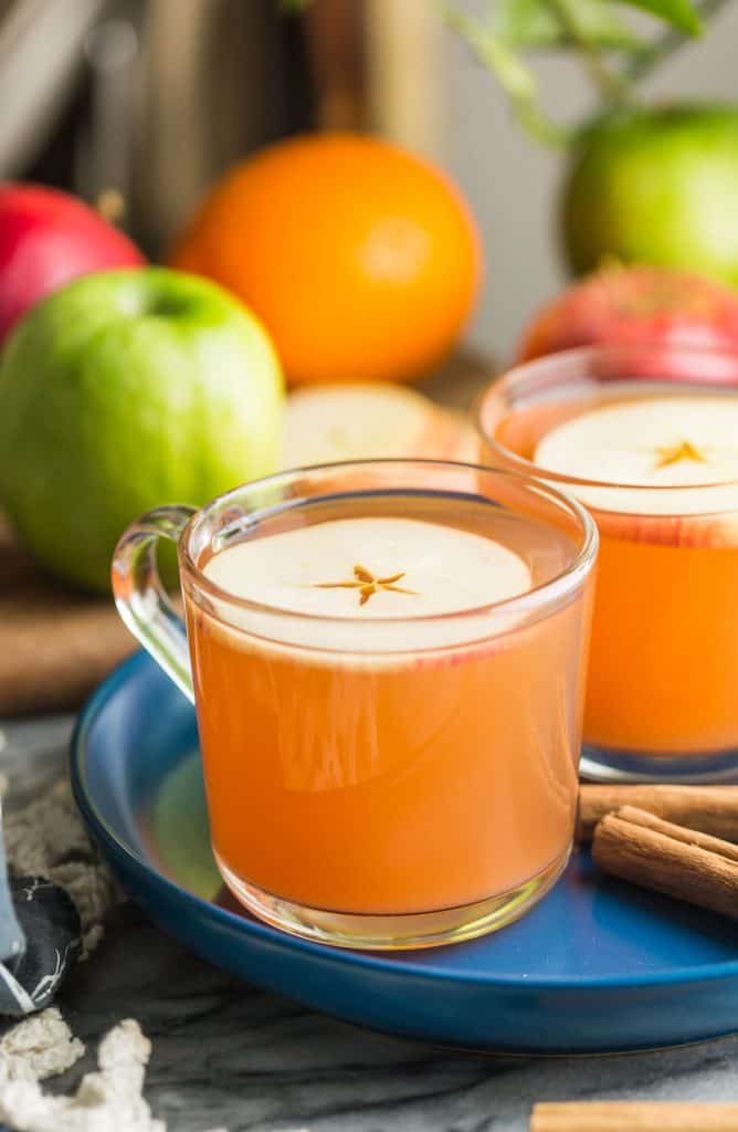 Instant Pot Apple Cider mugs with fruit in the back