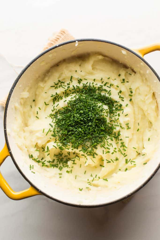 Vegan Mashed Potatoes without Milk in pot topped with chives