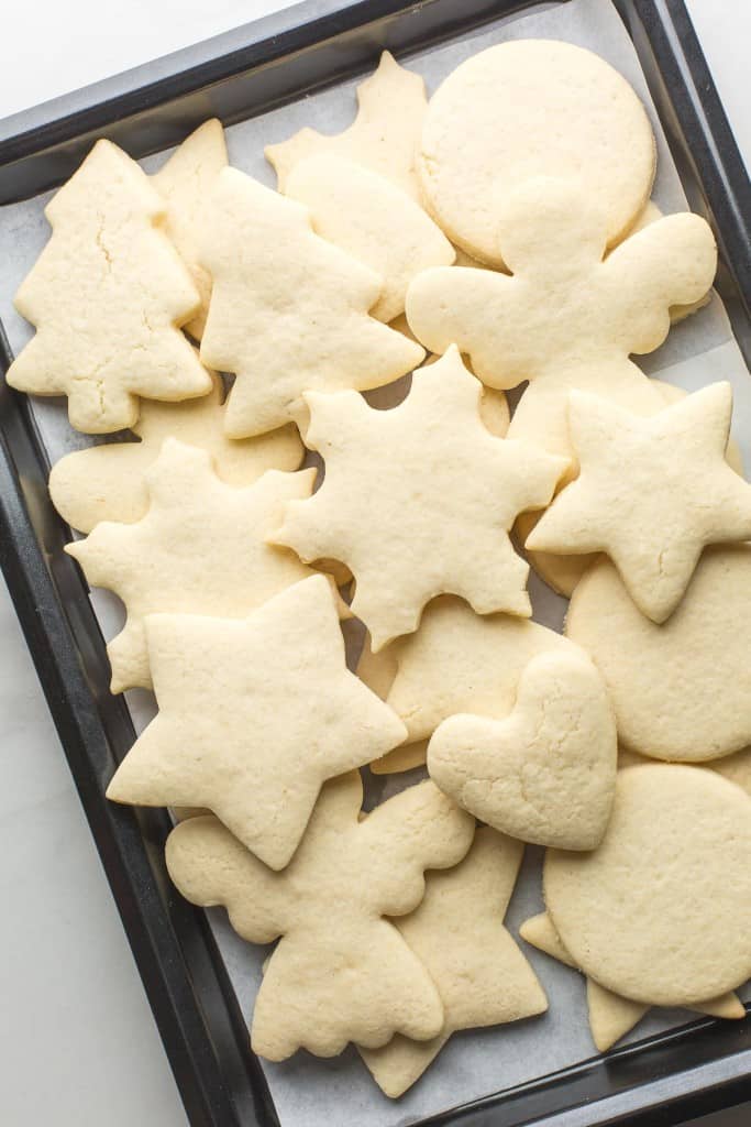 Gluten Free Sugar Cookies piled up and unfrosted on a baking sheet