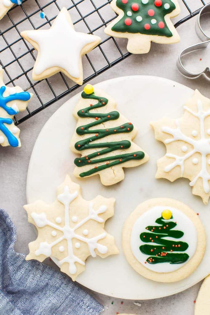 cutout Gluten Free Sugar Cookies  in the shape of snowflakes and christmas trees