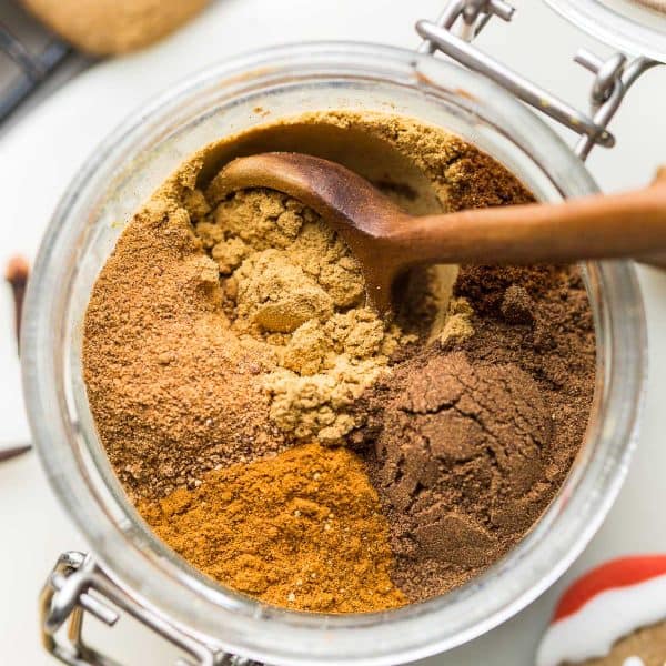 homemade gingerbread spice in a jar with a wooden spoon