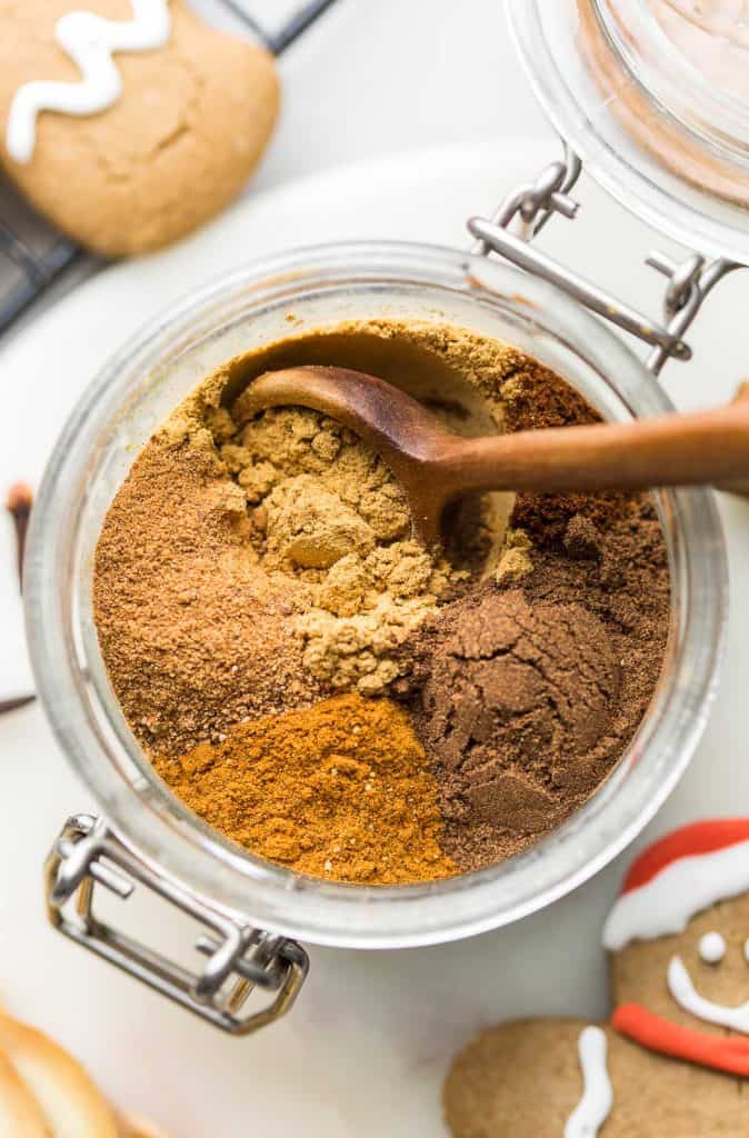 homemade gingerbread spice unmixed in a jar with a wooden spoon