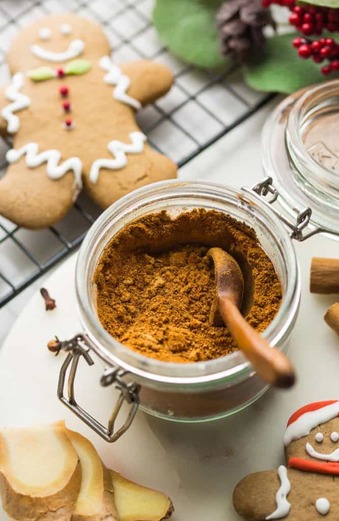 homemade gingerbread spice mixed together in a jar with a wooden spoon