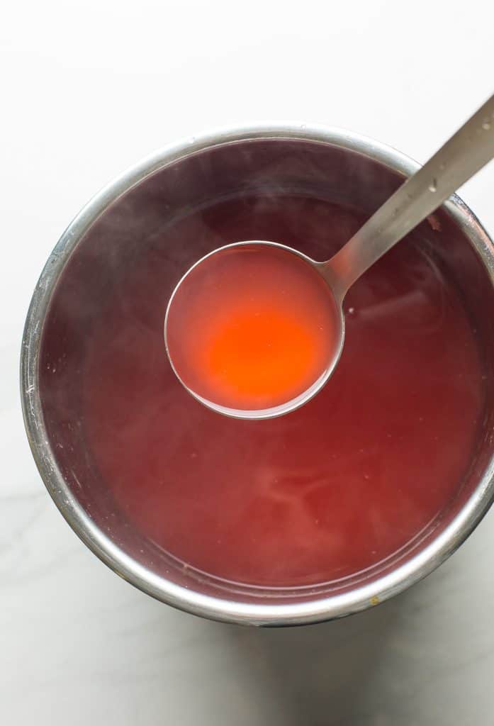 hot Cranberry Orange Juice in a pot with a soup laddle