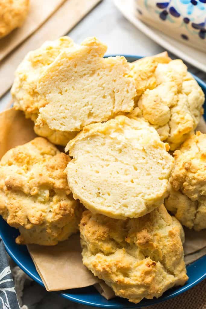 a plate of mashed potato biscuits with one cut in half