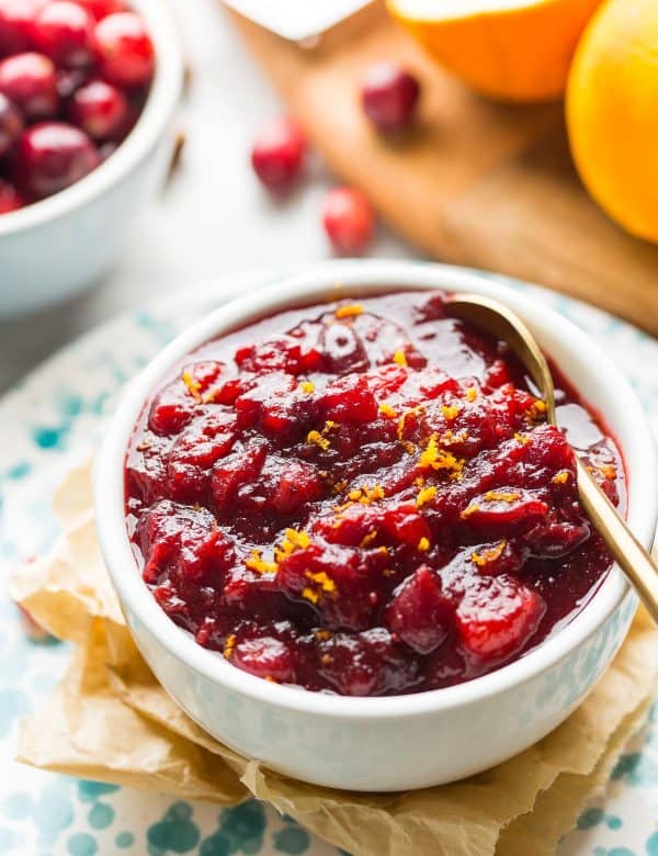 apple cranberry sauce in a bowl topped with orange zest