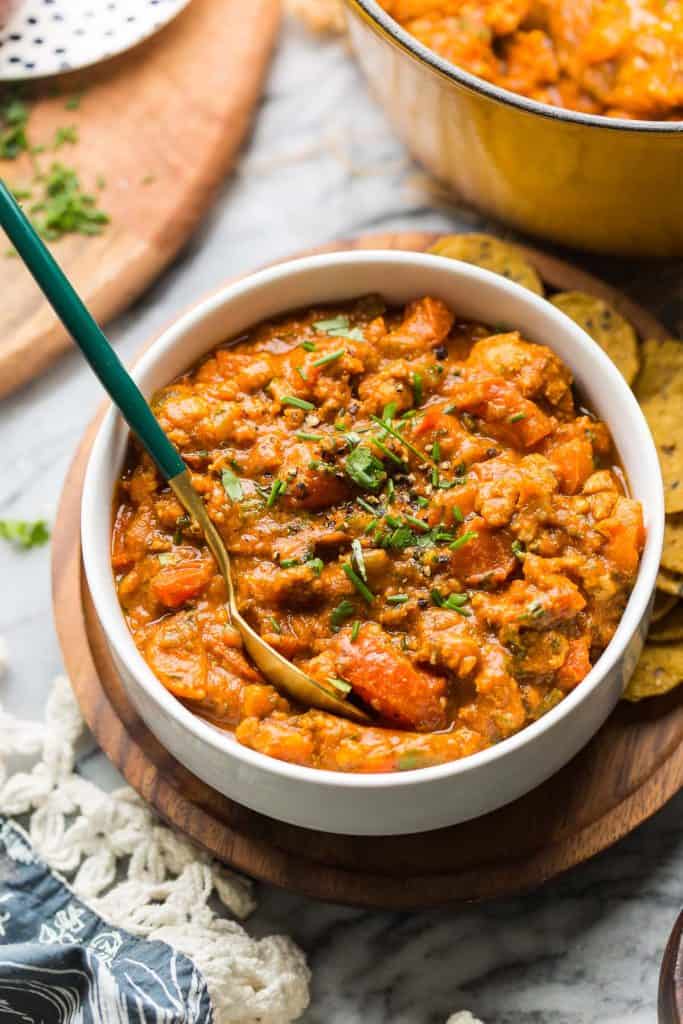 Low FODMAP Chili in a bowl topped with chopped chives