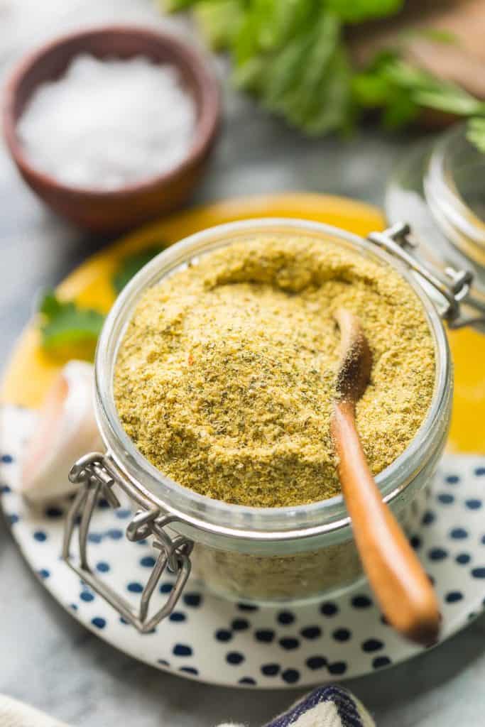 Homemade Vegetable Bouillon Powder in a small jar with a spoon