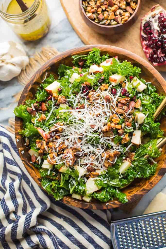 Winter Kale Salad topped with grated parmesan cheese in a salad bowl
