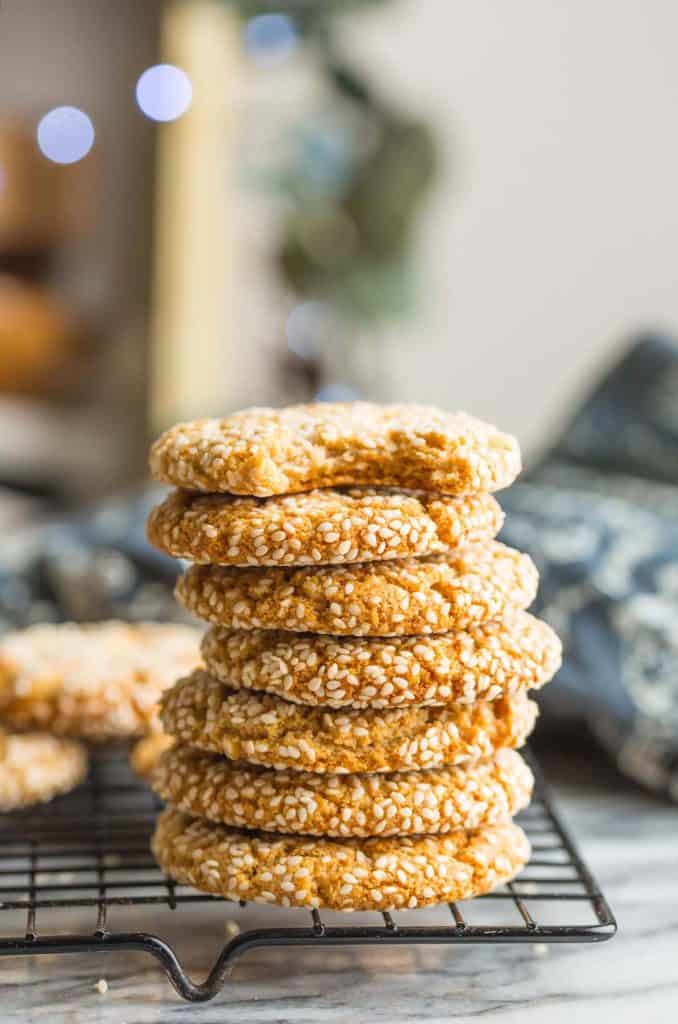 a stack of Tahini Cookies with a bite taken out of the top one