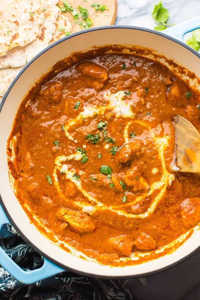 Dairy Free Butter Chicken in a large pot with a drizzle of coconut milk