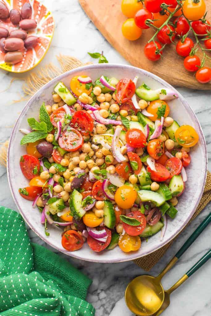 Greek Chickpea Salad in a bowl next to a kitchen napkin