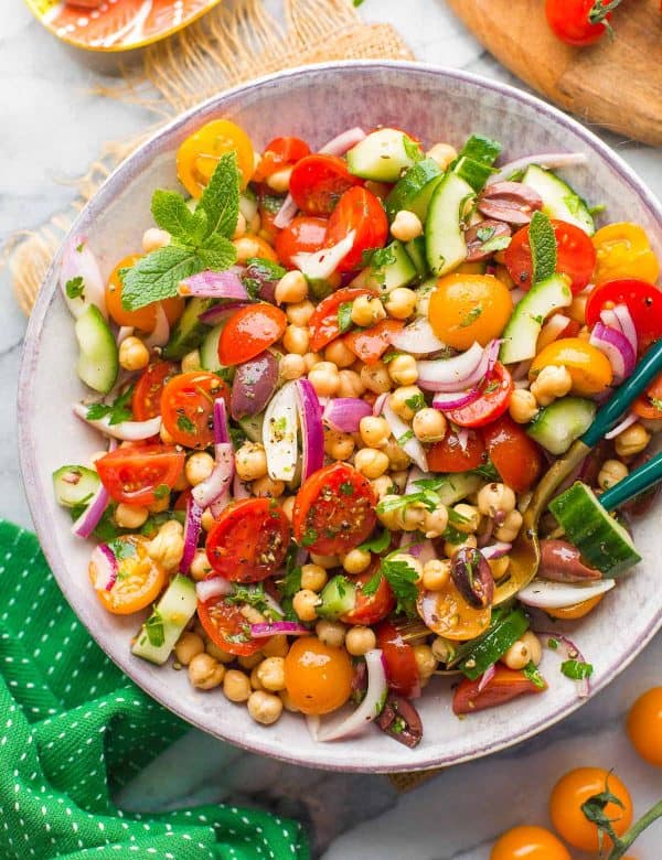 Greek Chickpea Salad in a bowl with serving spoons