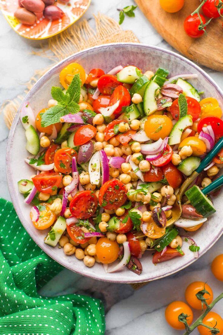 Greek Chickpea Salad in a bowl with serving spoons