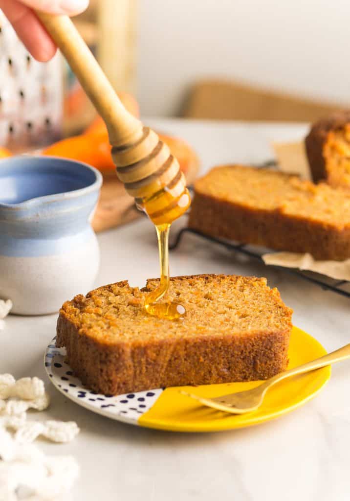 gluten free carrot cake with honey drizzling over a slice