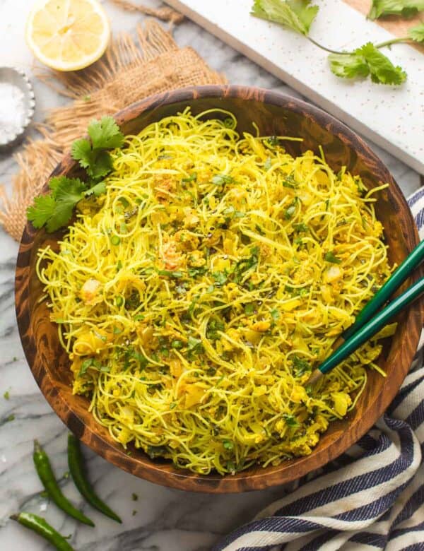 Bangladesh-Noodles in a serving bowl with serving spoons and topped with fresh cilantro