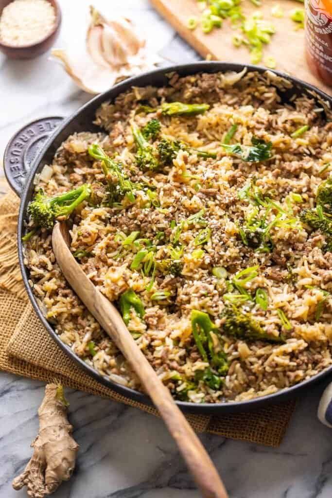 Ground Beef and Broccoli with Rice with a serving spoon