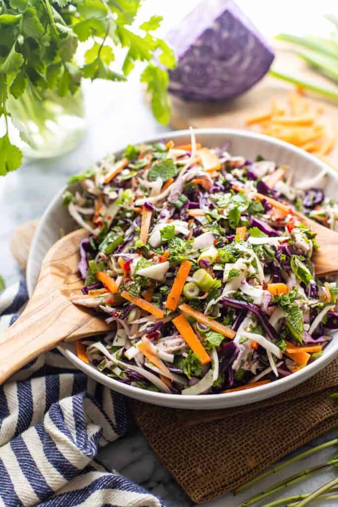 Vietnamese Chicken Salad in a salad bowl with serving tongs