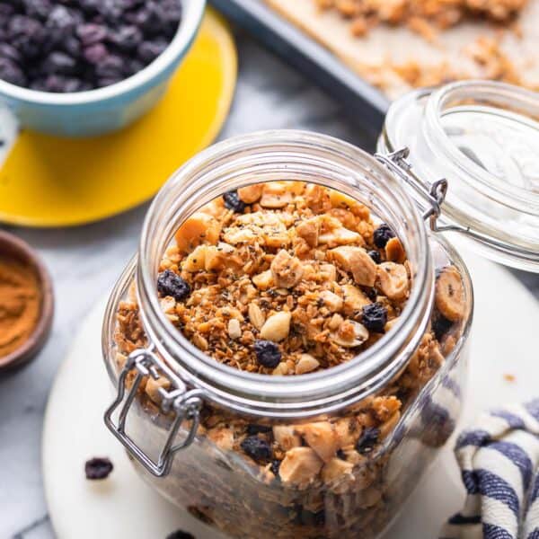 homemade grain free granola in a jars surrounded by the ingredients