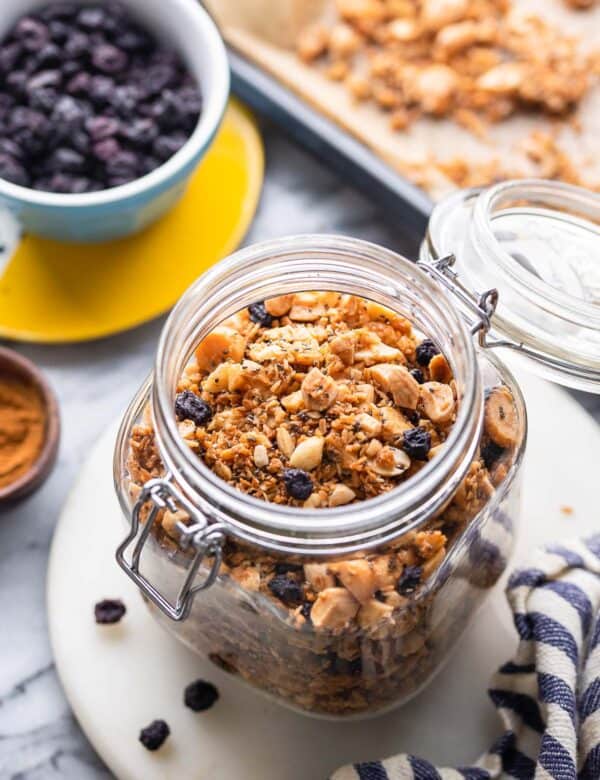 homemade grain free granola in a jars surrounded by the ingredients