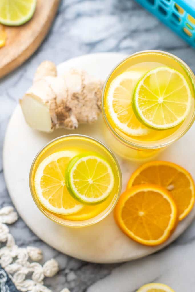 Homemade Electrolyte Drink garnished with lemon, lime and orange slices on a serving board