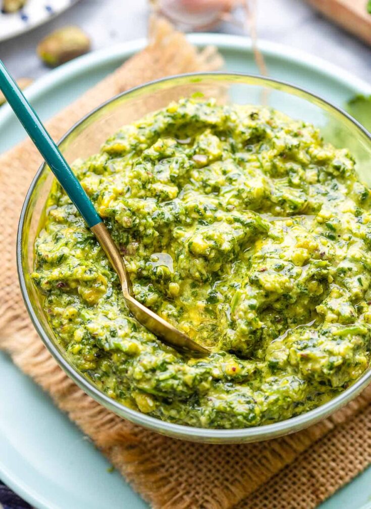 cilantro lime pesto in a small bowl with a spoon