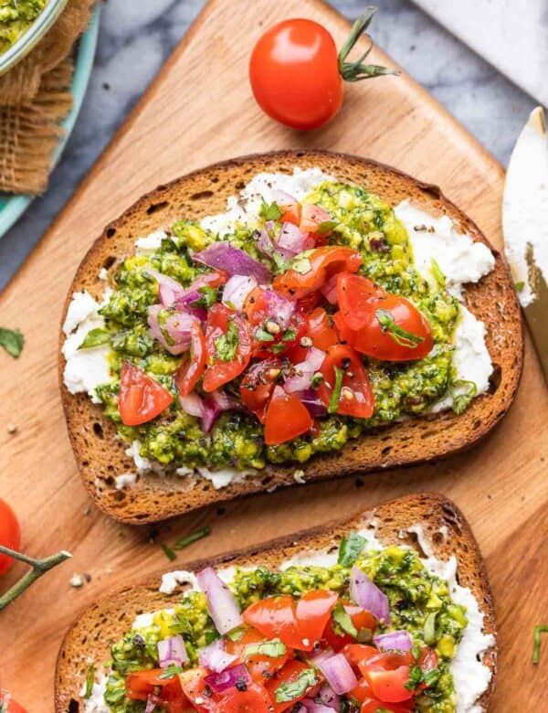 two pieces of Cilantro Lime Pesto Toast & Tomato Salsa on a serving board