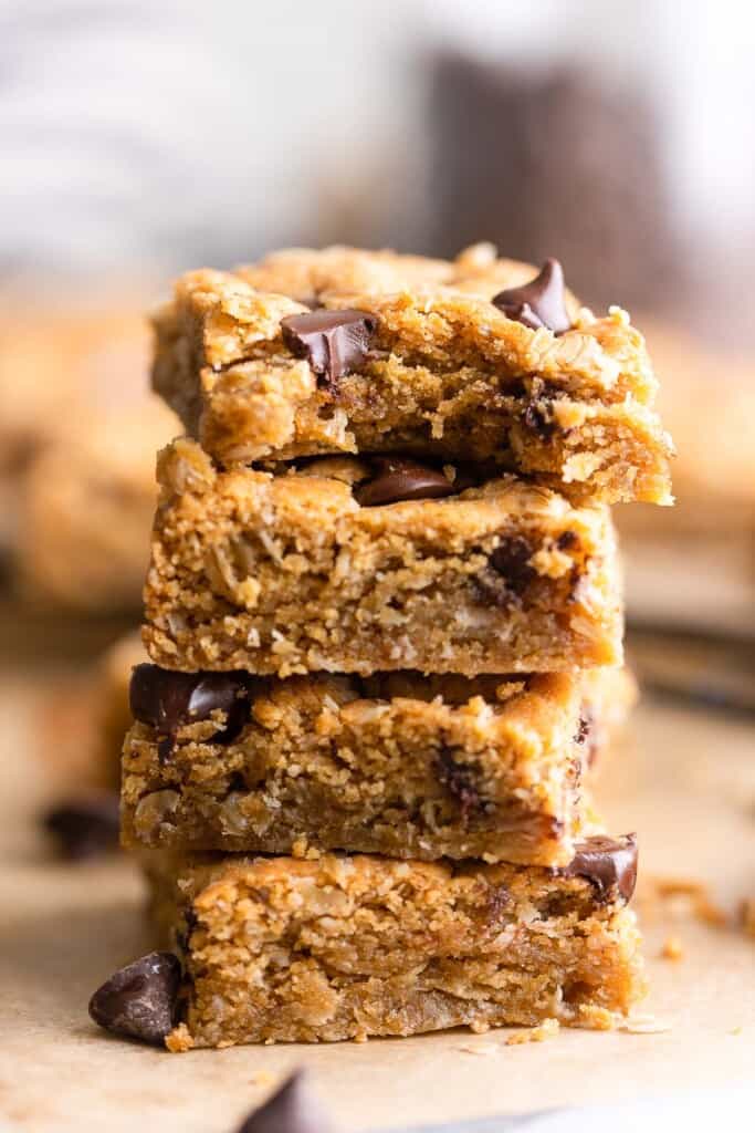a small stack of Peanut Butter Cookie Bars with Oats with a bite taken out of the top bar 