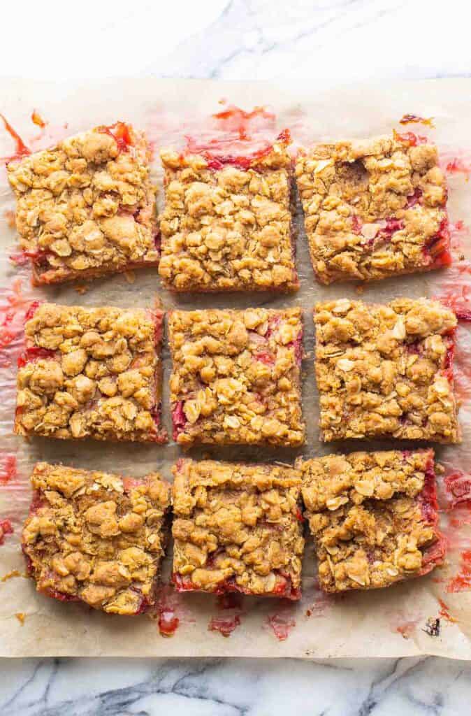 nine squares of Strawberry Rhubarb Bars on baking paper