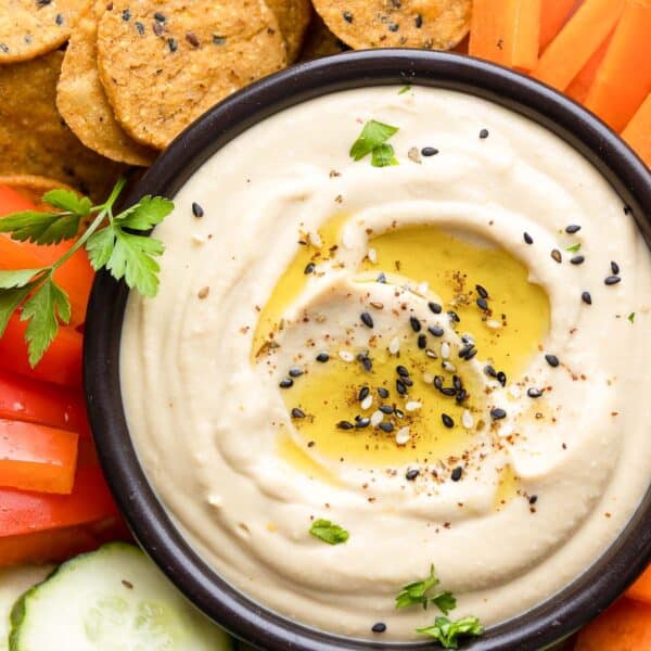 homemade hummus in a dipping bowl topped with za'atar spice and olive oil