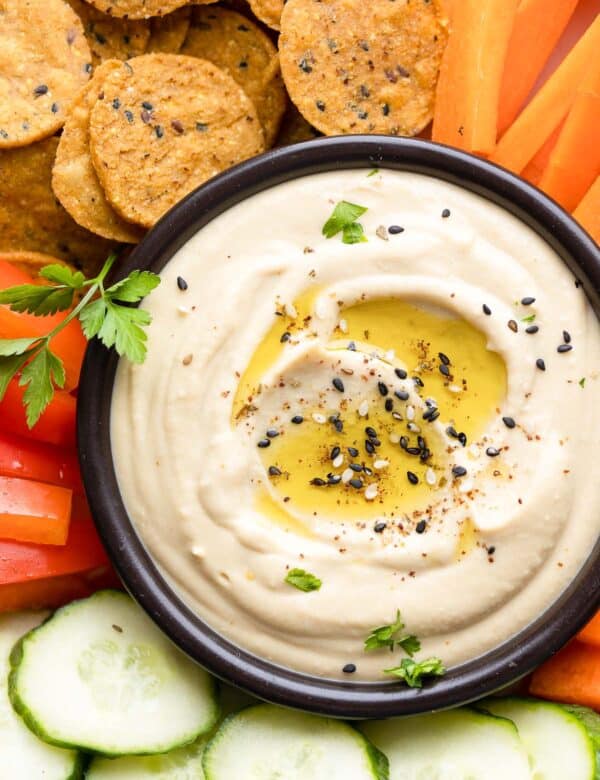 homemade hummus in a dipping bowl topped with za'atar spice and olive oil