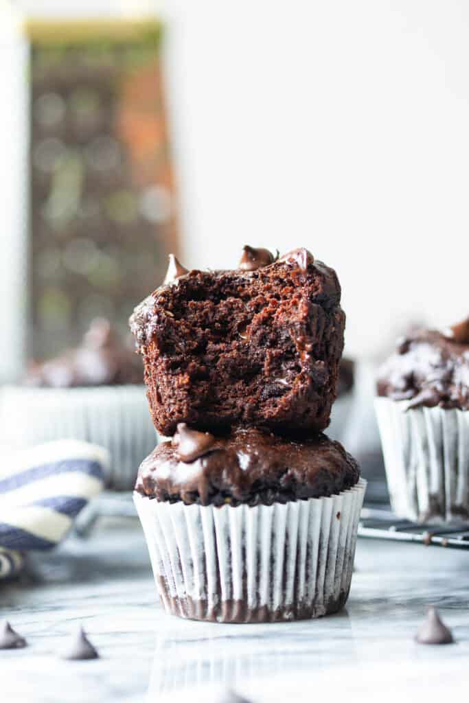 one Gluten Free Chocolate Zucchini Muffin stacked on top of another