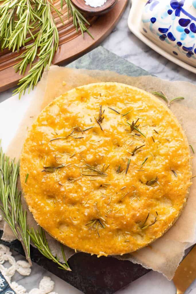  fresh Focaccia on a serving board brushed with garlic butter