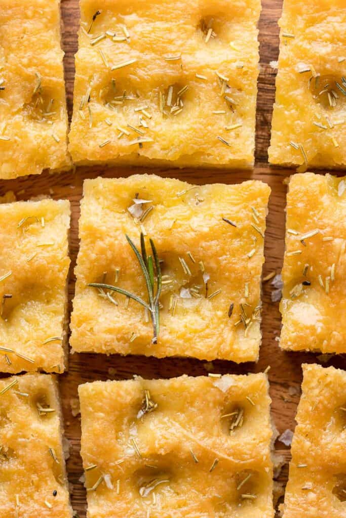 Gluten Free Focaccia cut into square slices and topped with rosemary and sea salt