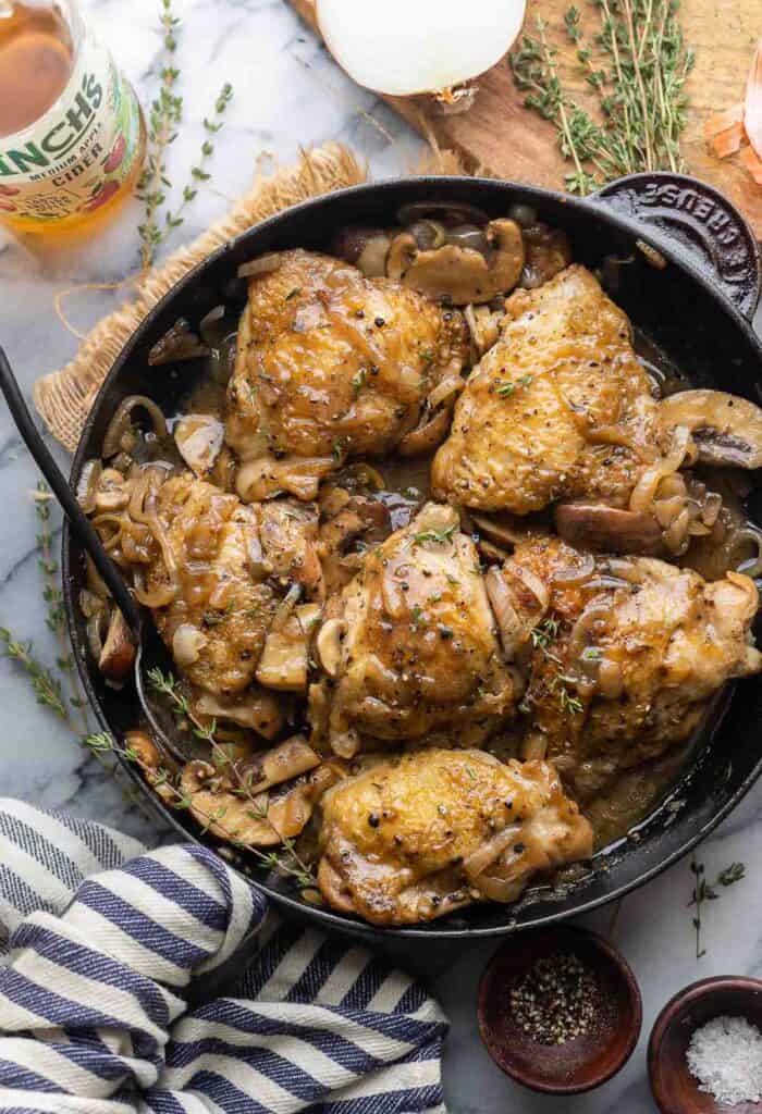 Apple Cider Braised Chicken Thighs in a cast iron skill