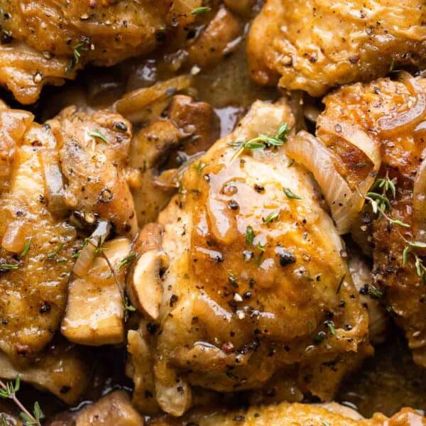 Apple Cider Braised Chicken Thighs topped with fresh thyme