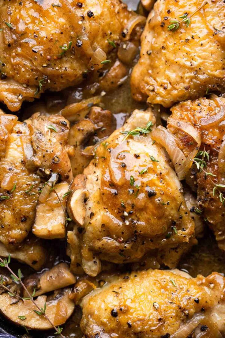 Apple Cider Braised Chicken Thighs topped with fresh thyme