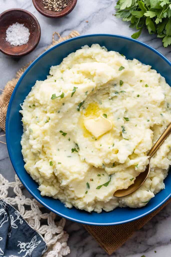 Creamy Mashed Cauliflower with fresh chives and butter melting on top