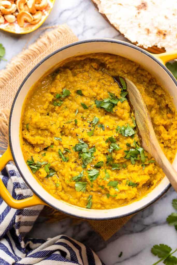 Red Lentil Dahl in a pot topped with fresh cilantro