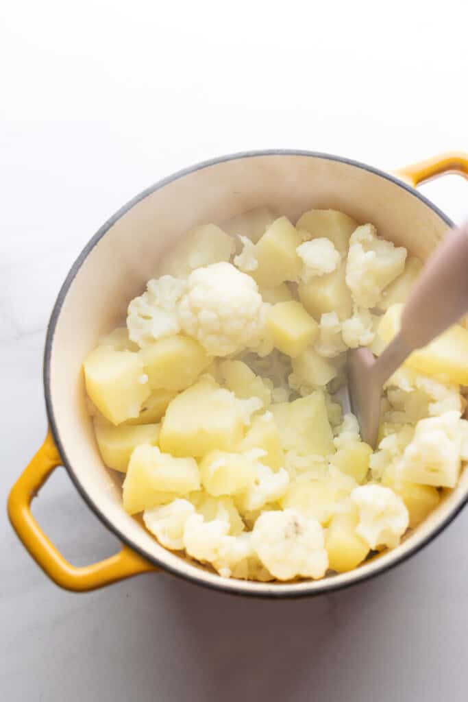 boiled mashed potatoes with cauliflower in pot