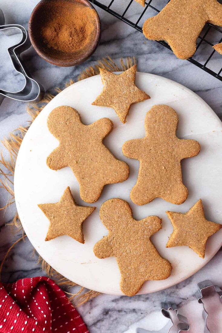 paleo gingerbread cookies in the shape of gingerbread men and stars on a round platter