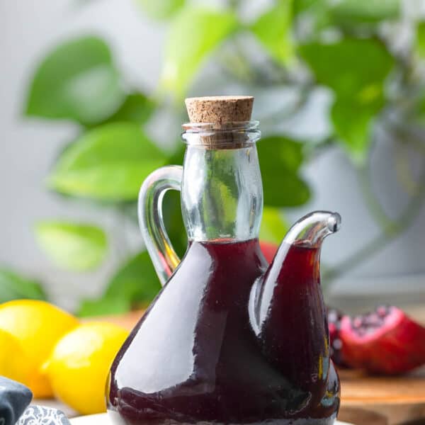 Homemade Grenadine Syrup in a glass bottle with a pouring spout