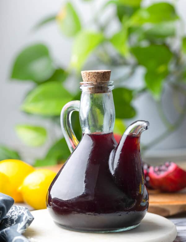 Homemade Grenadine Syrup in a glass bottle with a pouring spout